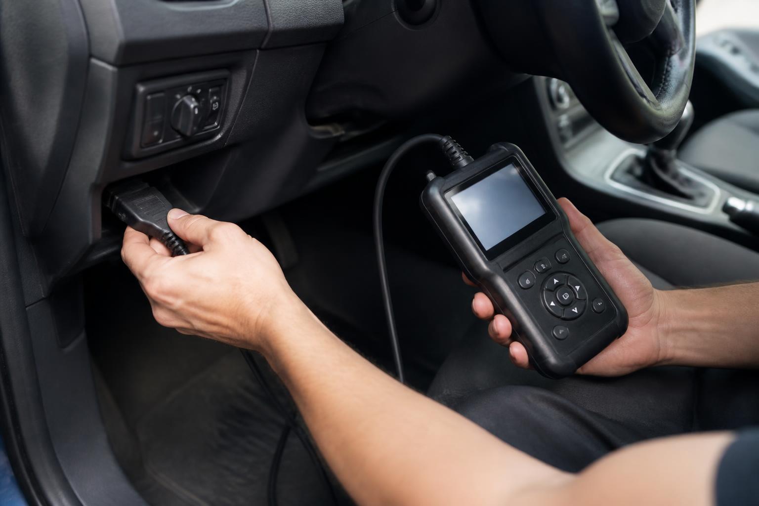 Mechanic running a diagnostic scan tool on a used Ford Ranger ute at a Liverpool address